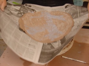 carrying the slab on a piece of newspaper