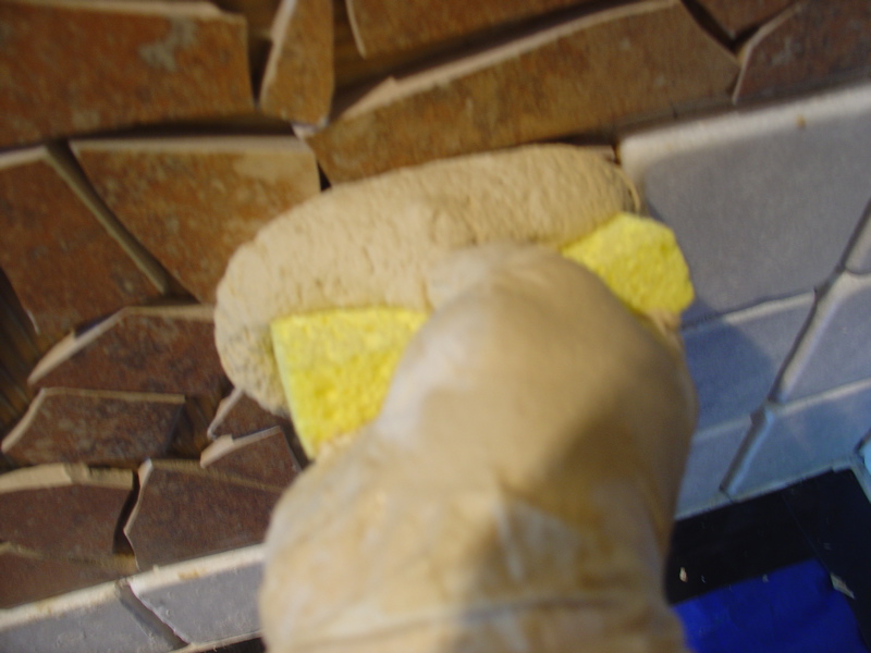 using a sponge to apply the grout